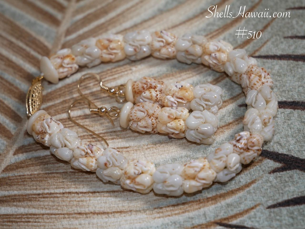 Close-up photo of matching earrings and bracelet set created in traditional crown flower style technique using very small-sized light blue ʻŪliʻuli and light yellow Lenalena Momi shells, showing shell quality, delicate pattern, fine workmanship, and natural shell luster.