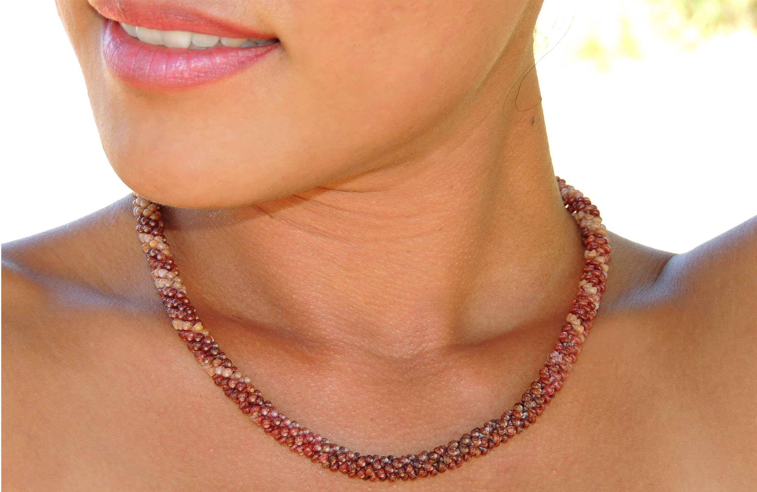 Niʻihau Kahelelani shell necklace modeled by Janjira, the owner of ShellsHawaii.com, during an outdoor beach photoshoot on Kauaʻi.