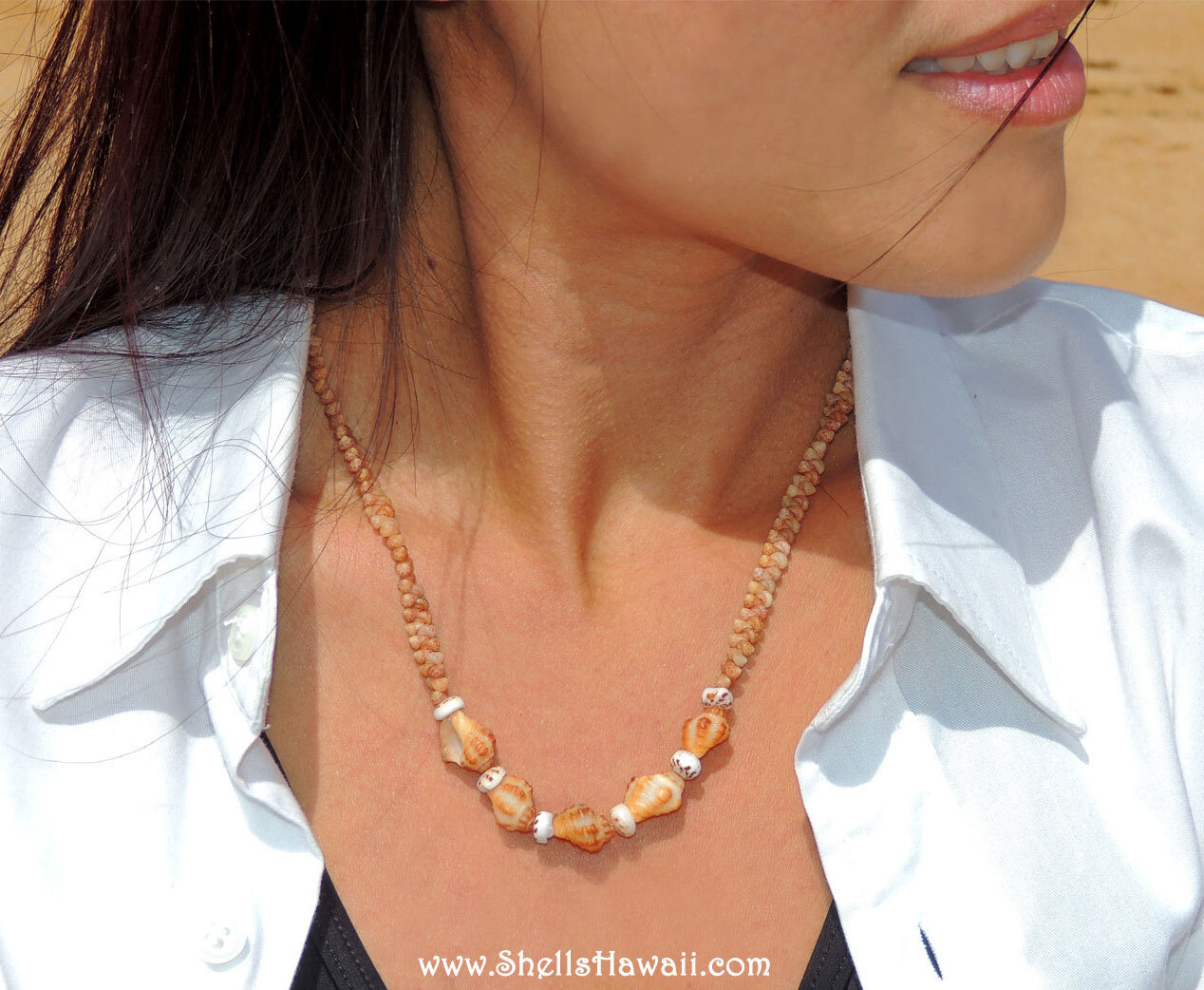 Janjira, owner of ShellsHawaii.com, modeling a handmade Hawaiian shell necklace in natural beach sunlight for her jewelry photography.