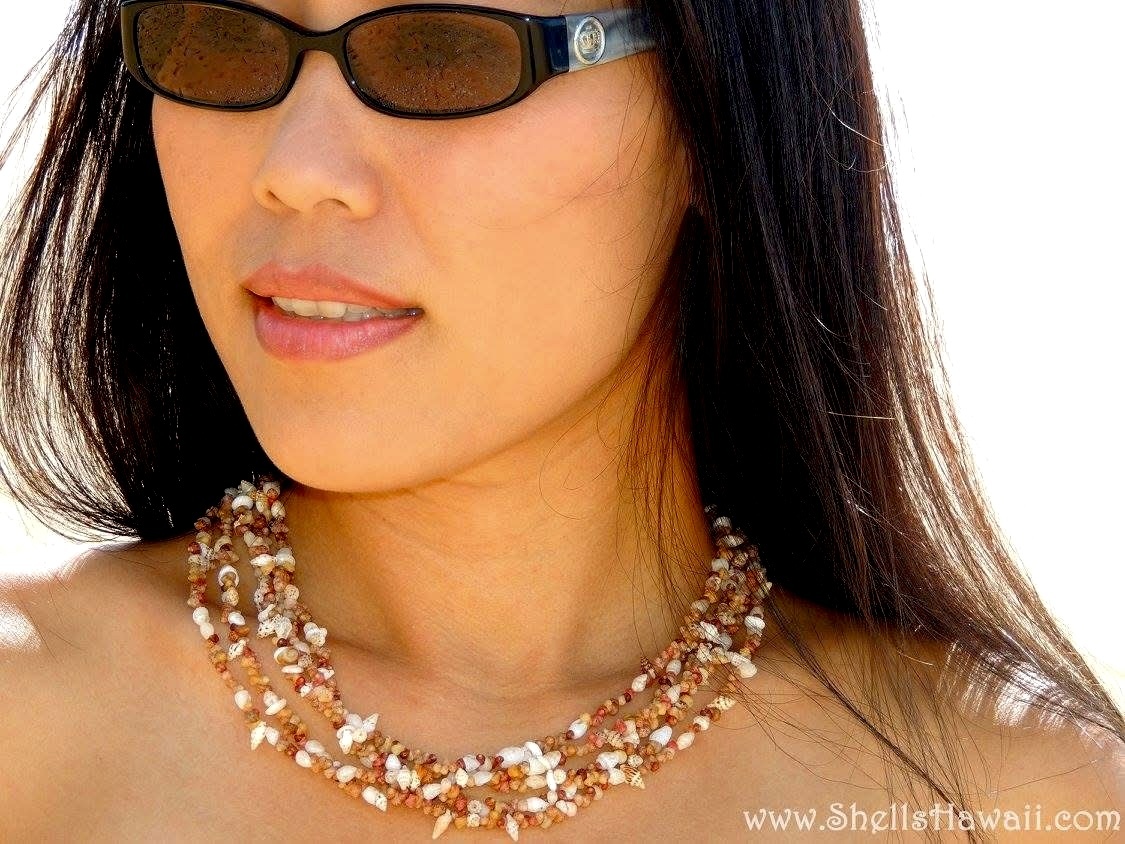 Niʻihau and Kauaʻi shell necklace in playful popcorn-style practice design, featuring Kahelelani shells from Kauaʻi mixed with Hawaiian seashells including Momi, Laiki, and Puka shells from Niʻihau, shown worn by Janjira, owner of ShellsHawaii, to highlight how the necklace looks in person, its natural beauty, texture, and relaxed layered style.