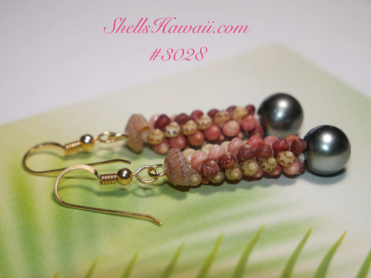 Close-up of handcrafted Hawaiian Kahelelani shell earrings in Poepoe style featuring colorful Niʻihau shells paired with dark Tahitian pearls and gold filled hooks in an elegant island-inspired jewelry design.