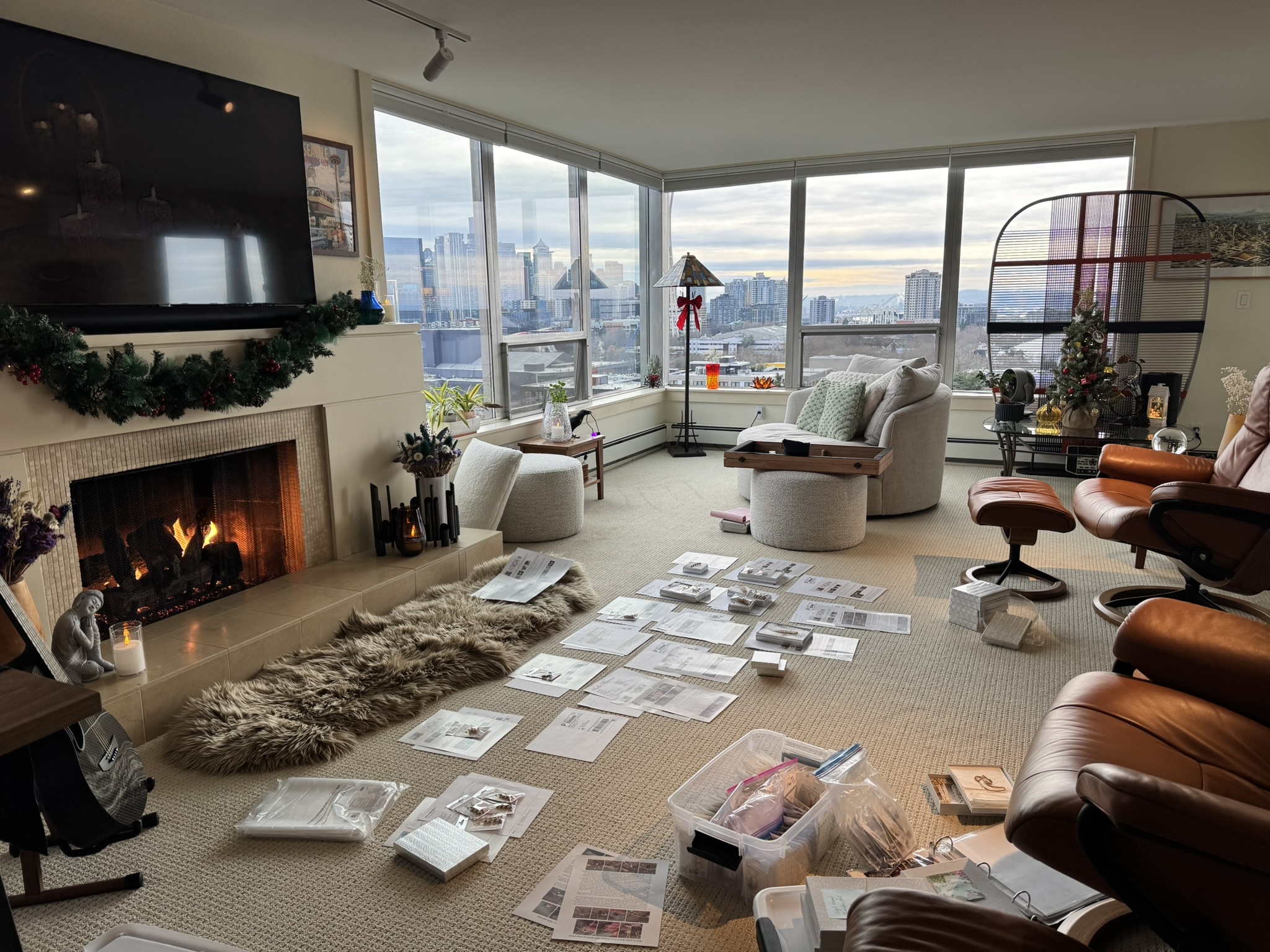 Behind the scenes holiday packing of Niʻihau shell jewelry orders laid out on the living room floor, showing handwritten notes, gift boxes, and carefully prepared packages ready to ship with aloha