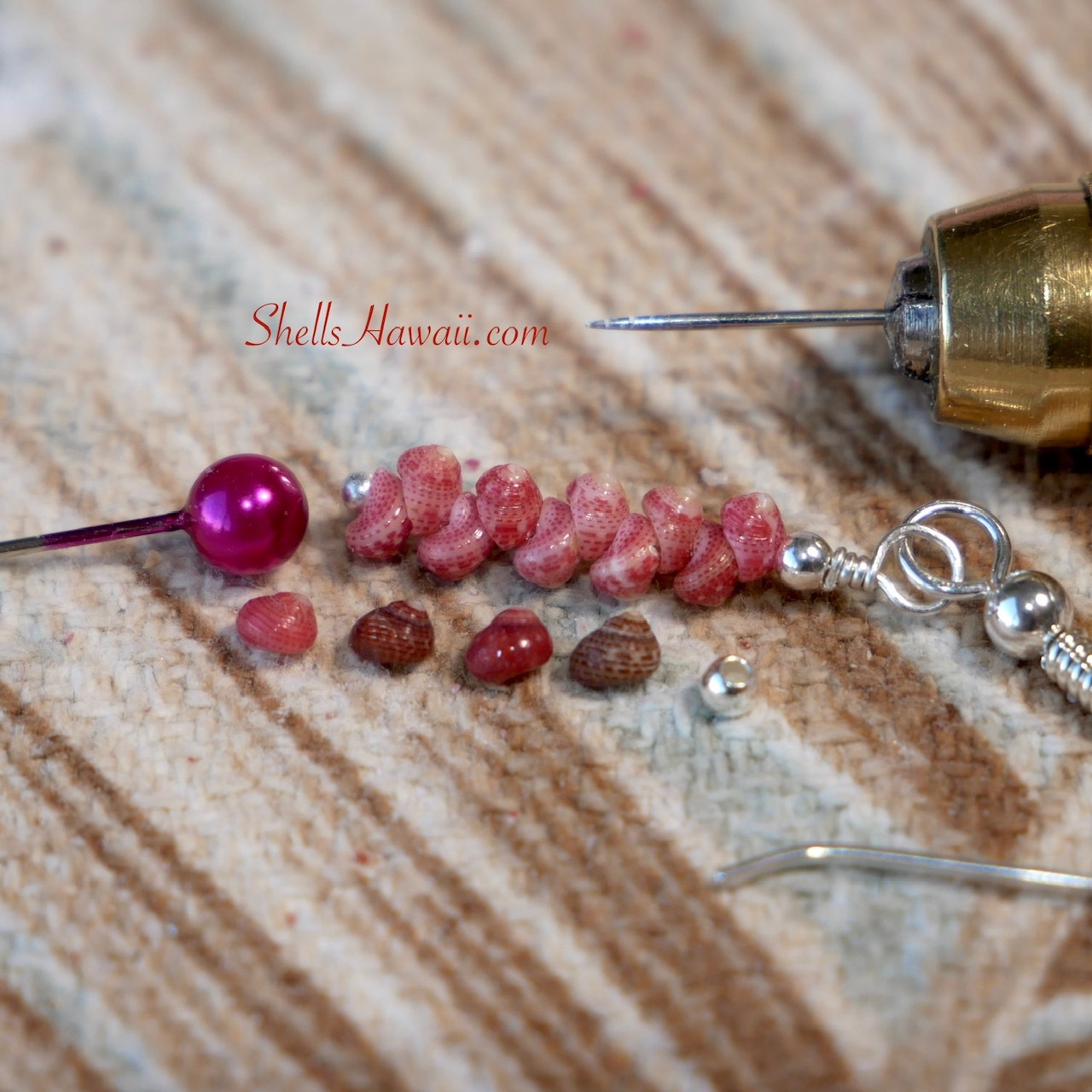 Kahelelani shell size comparison showing how tiny these shells really are, featuring sizes 8 to 10 placed next to small size spacer bead, alongside a finished minimalist earring made with pink ʻĀkala Pua Kahelelani size 10, displayed next to a head pin for scale and comparison