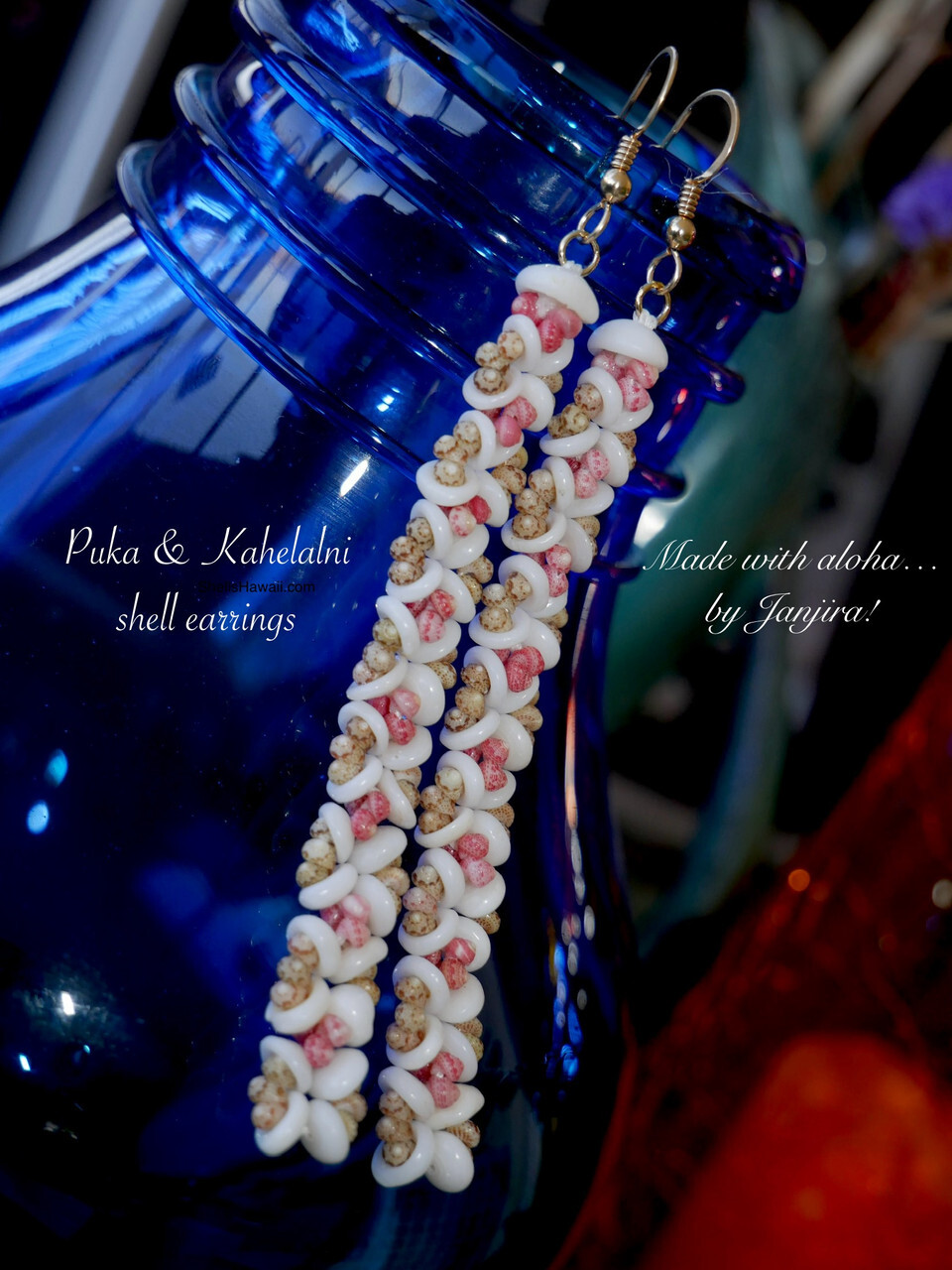 Close-up of handcrafted Hawaiian shell earrings featuring natural Puka shells beautifully combined with tiny colorful Kahelelani shells from Niʻihau in a soft plumeria-inspired design. The delicate arrangement highlights the natural shell colors, detailed craftsmanship, and traditional island-inspired Hawaiian shell jewelry style.
