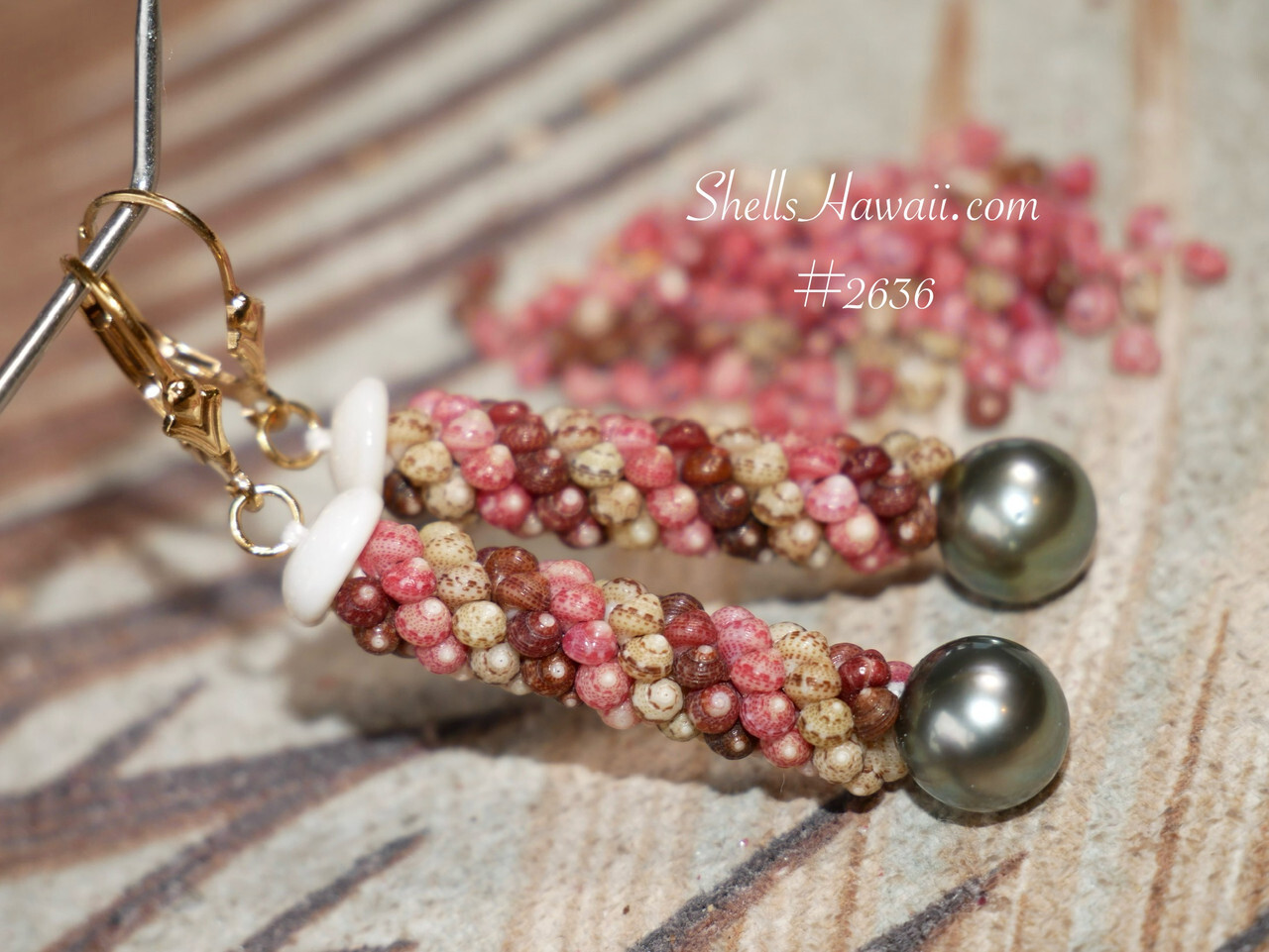 Close-up of handcrafted Niʻihau triple strand Poepoe style earrings featuring colorful Kahelelani shells paired with dark Tahitian pearls and gold filled findings in an elegant Hawaiian shell jewelry design.