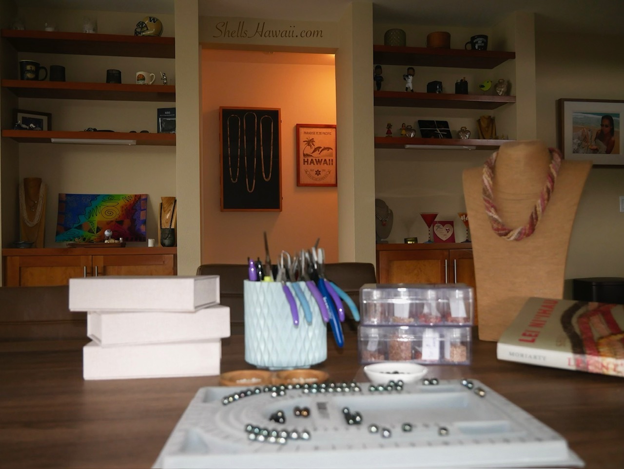 Behind the scenes at ShellsHawaii work table featuring Tahitian pearls, Hawaiian shell jewelry designs, and upcoming handmade Niʻihau shell jewelry creations.